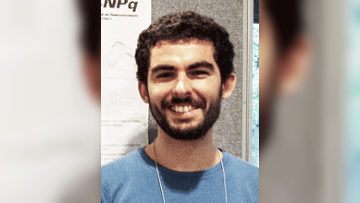 A head and shoulders photo of Francisco smiling, wearing a blue tshirt