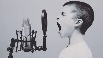 child speaking into microphone
