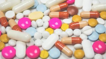 Different coloured tablets scattered on a white surface
