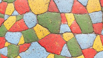 Cracked pavement bits painted in 4 colors top view. Four color theorem.