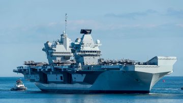 HMS Queen Elizabeth arriving at Portsmouth Harbour with F35 aircraft on deck © Chris Pearsall|Alamy Stock Photo.