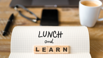 Laptop and coffee cup with text reading Lunch and learn
