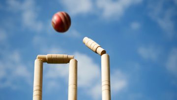 Cricket ball hitting wicket